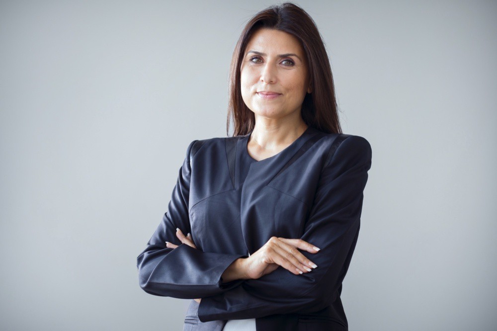 Portrait of businesswoman on grey background